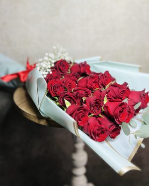 Two dozen red roses wrapped bouquet